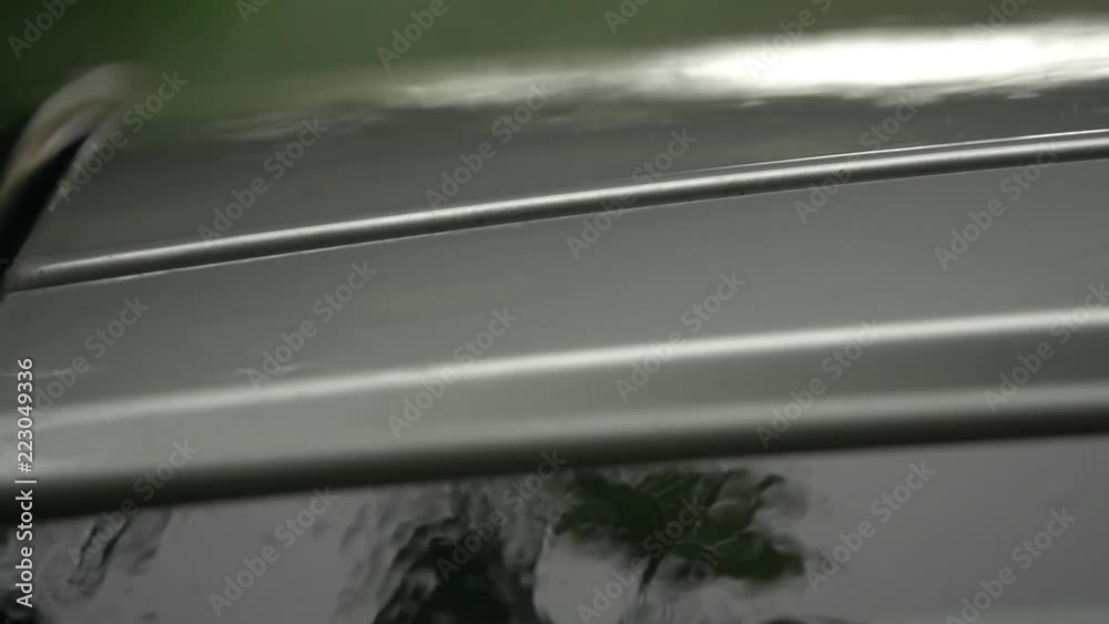 Parked car in the rain. Slow motion
Parked car in the rain. Slow motion