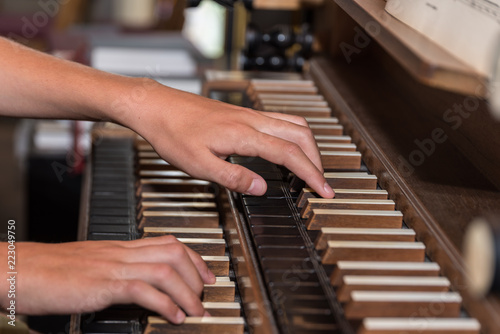 Person plays organ - close-up photo