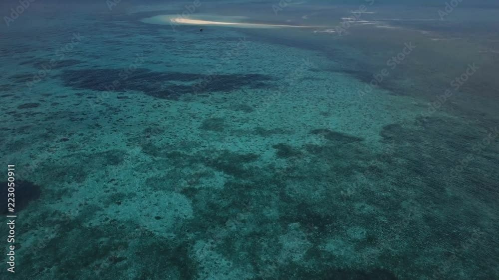 Aerial: A small island, a lost island, beautiful azure water, an island for two, zanzibar, Maldives Aerial: A small island, a lost island, beautiful azure water, an island for two, zanzibar, Maldives
