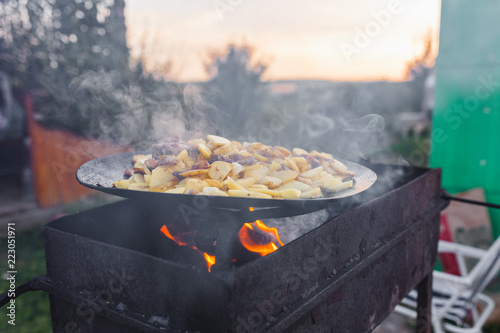 fry potatoes on open fire in the open air