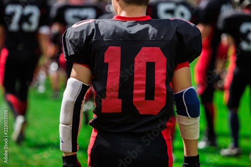 American Football Player With Teammates In Background Close-up