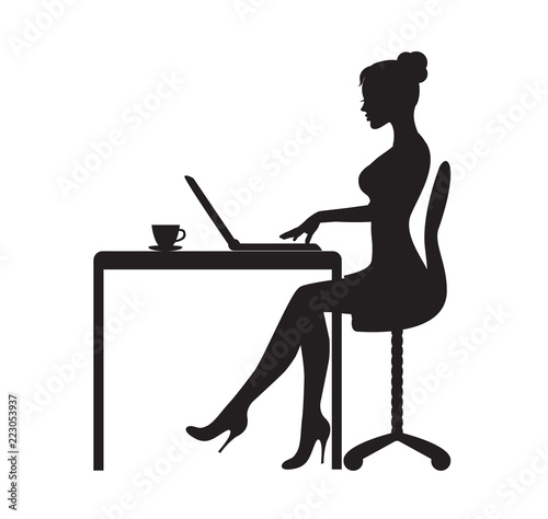
black silhouette of woman sitting at table with laptop. On the table is a mug with tea