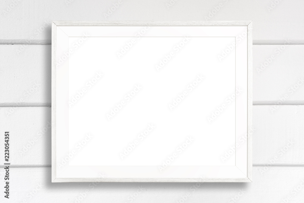 Fototapeta premium Blank white picture frame on white wood background.