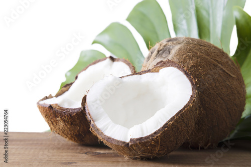 natural coconut open in half on wood and leaf