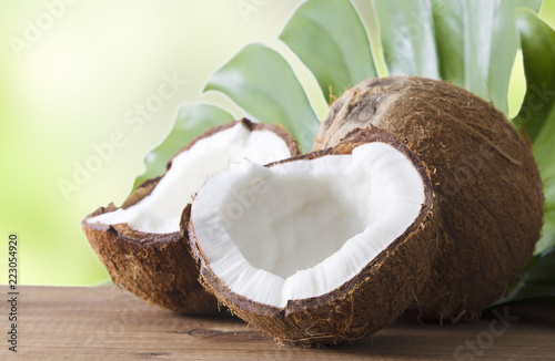 natural coconut open in half on wood and leaf