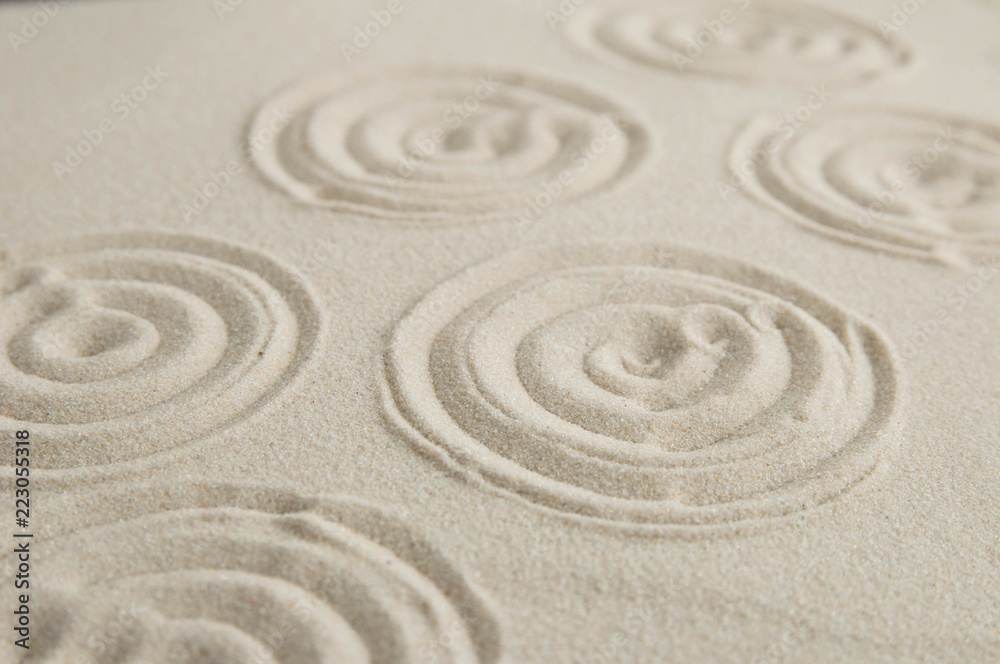 Fototapeta Zen drawing on white sand. Concept of harmony, balance and meditation, spa, massage, relax