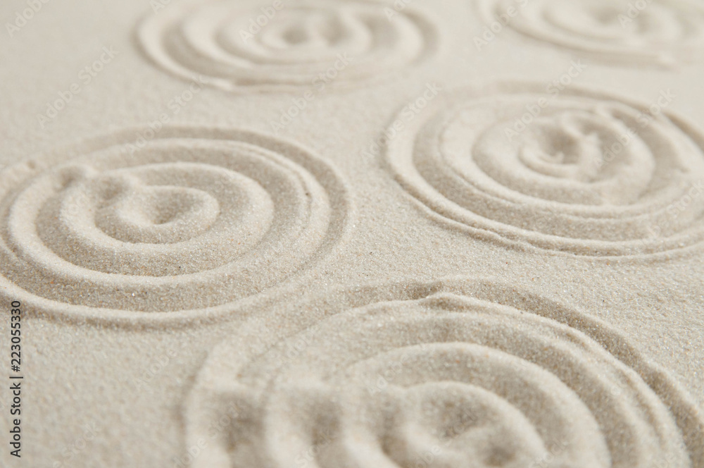 Fototapeta Zen drawing on white sand. Concept of harmony, balance and meditation, spa, massage, relax