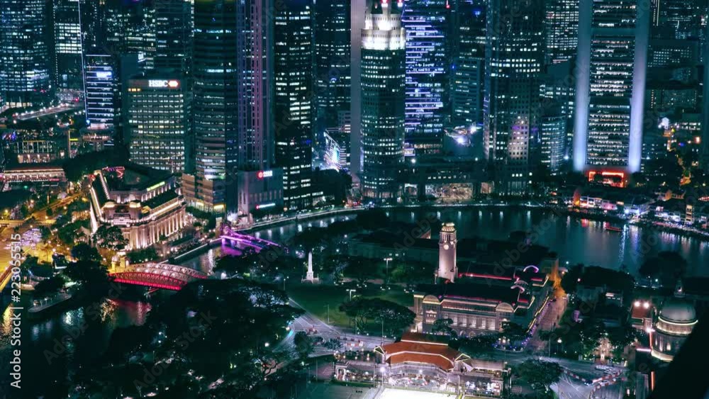 SINGAPORE - OCT 19, 2017: Fantastic night view of Singapore city center with beautiful historical buildings illuminated by colorful lights against river and Marina Bay Financial Centre on background.
