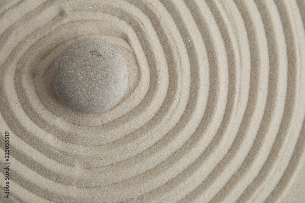 Pyramids of gray zen stones on the sand with wave drawings. Concept of harmony, balance and meditation, spa, massage, relax Pyramids of gray zen stones on the sand with wave drawings. Concept of harmony, balance and meditation, spa, massage, relax