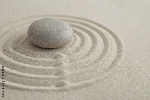 Pyramids of gray zen stones on the sand with wave drawings. Concept of harmony  balance and meditation  spa  massage  relax