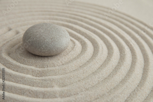 Pyramids of gray zen stones on the sand with wave drawings. Concept of harmony  balance and meditation  spa  massage  relax