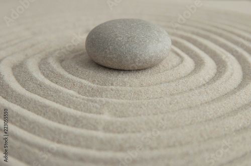 Pyramids of gray zen stones on the sand with wave drawings. Concept of harmony  balance and meditation  spa  massage  relax