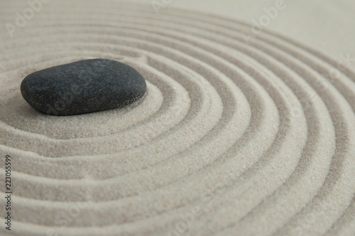 Pyramids of gray zen stones on the sand with wave drawings. Concept of harmony  balance and meditation  spa  massage  relax