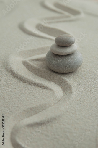 Photography Pyramids of gray zen stones on the sand with wave drawings