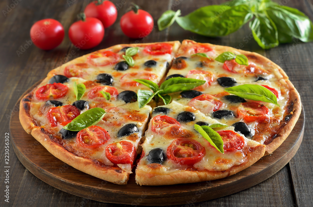 Sliced pizza with tomato and olives