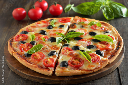 Sliced pizza with tomato and olives