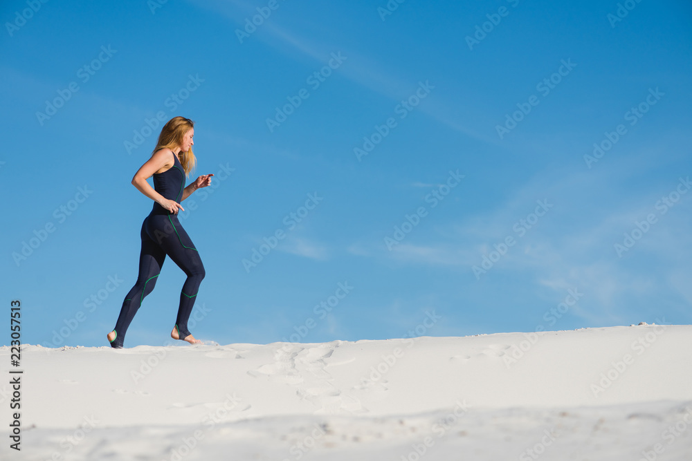 Pretty young female jogging in the desert Pretty young female jogging in the desert