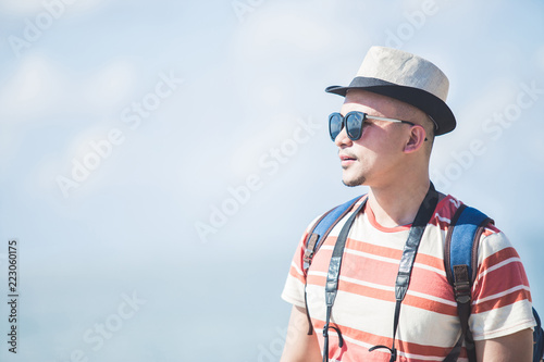 solo traveller wearing summer hat and sunglasses during vacation © Odua Images