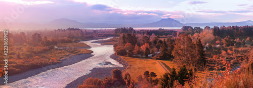 Picturesque sunset over Tongariro river and lake Taupo