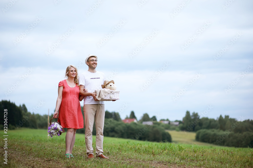 Fototapeta premium Pregnant girl with big belly and young man outdoor