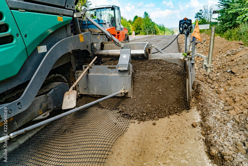 Obraz premium special technique for leveling the ground is on the road when repairing road works