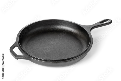 Empty, clean black cast iron pan or dutch oven over white