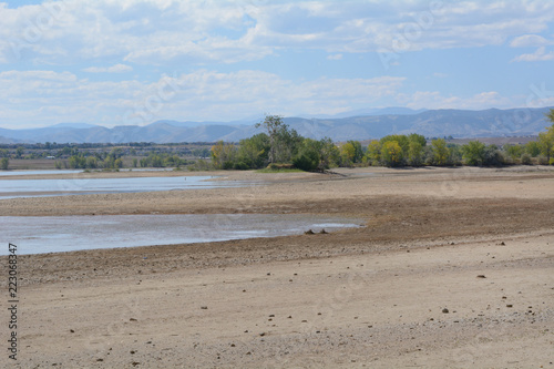 Increase of dry beach land with decreasing water level at Lake Standley reservoir in Westminster Colorado