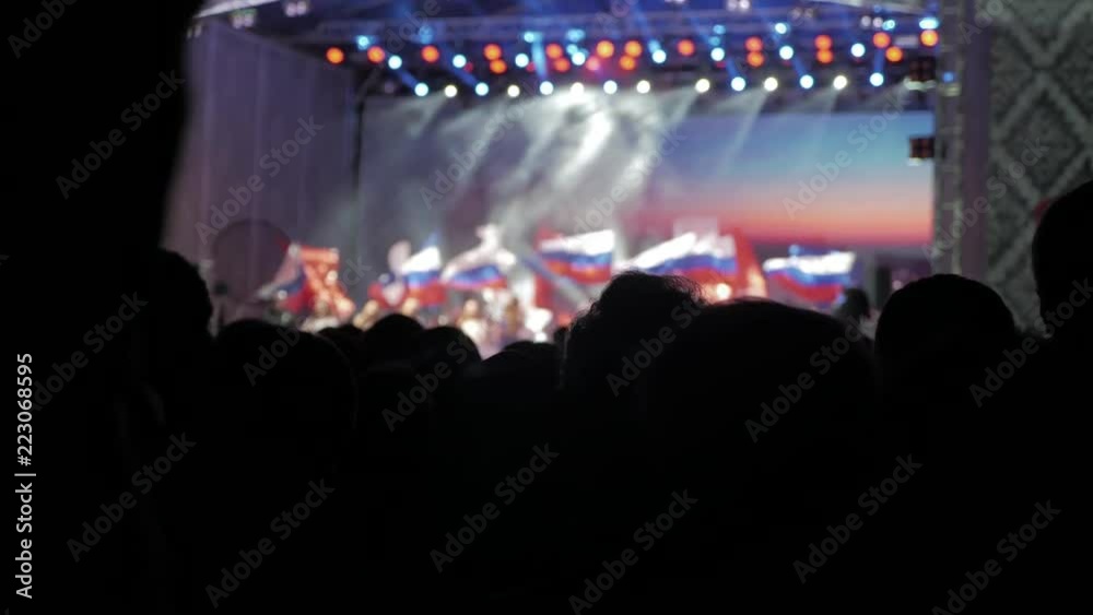 Crowd at concert. Cheering crowd in front of bright colorful stage lights. silhouettes of concert crowd in front of bright stage lights. crowd of people at a concert concept night lifestyle