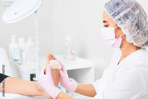 Patient on medical pedicure procedure visiting podiatrist.Podologic polymer gel plates.Protecting the skin ulceration.Bedsore prevention.Foot treatment in SPA salon.Podiatry clinic. photo