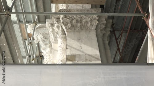 Renovation on the 11th century St. Martin dome, Lucca, capital and scaffolding. Restoration of famous church facade, exterior restoring works, conservation of old building in Tuscany, Italy