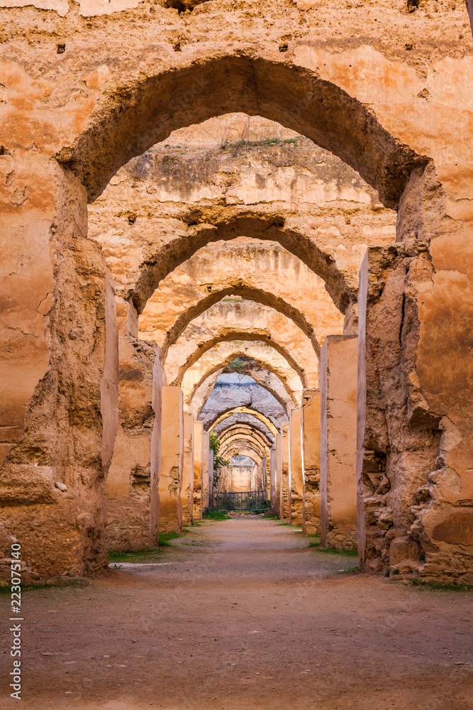 The ruined arches of the massive Royal Stables in the Imperial City of Meknes, Morocco