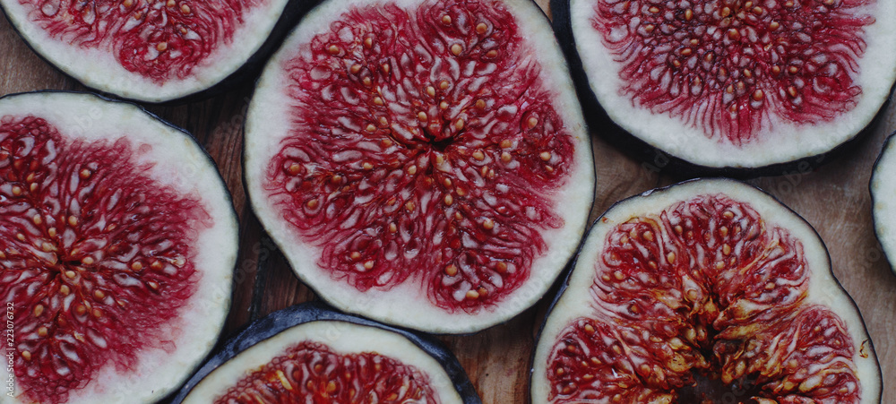 Fresh organic ripe figs on rustic wooden board. Healthy lifestyle, seasonal fruit, sweet dessert, top view