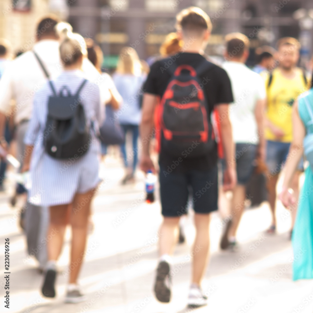 people take a leisurely walk through the summer sunny city, a blurred background people take a leisurely walk through the summer sunny city, a blurred background