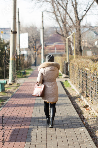 Girl walking on the path of the sidewalk