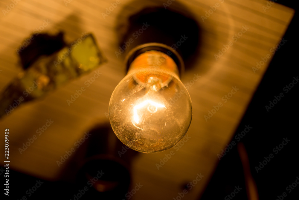 light bulb lit on a black background ,soft focus light bulb lit on a black background ,soft focus