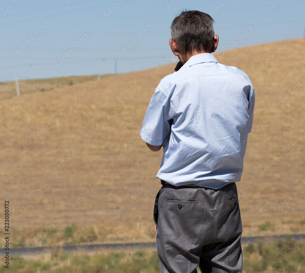 Naklejka premium a man in a field thinking