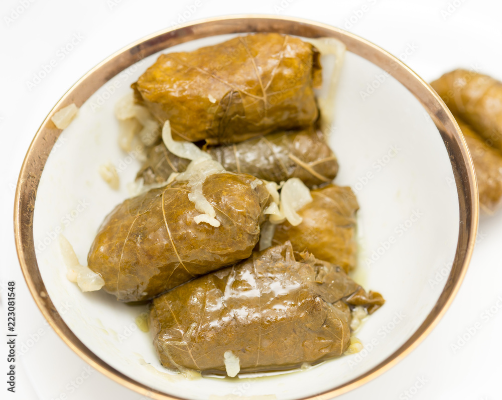 dolma, stuffed grape leaves on a white background dolma, stuffed grape leaves on a white background
