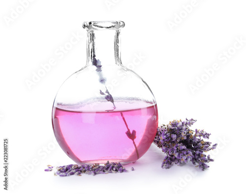Fototapeta Naklejka Na Ścianę i Meble -  Flask with aromatic lavender oil on white background