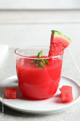 Summer watermelon drink with mint in glass served on table