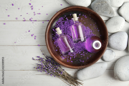 Fototapeta Naklejka Na Ścianę i Meble -  Flat lay composition with natural herbal oil and lavender flowers on wooden background