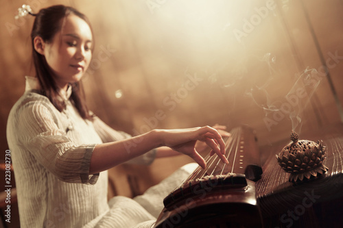 Young woman playing the lyre photo