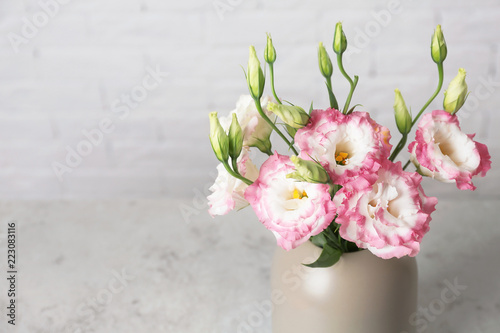 Beautiful flowers in vase as element of interior design on table. Space for text