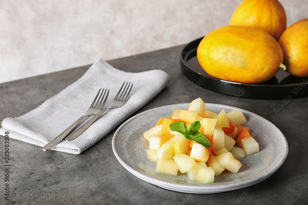 Plate of salad with assorted melons on table Plate of salad with assorted melons on table