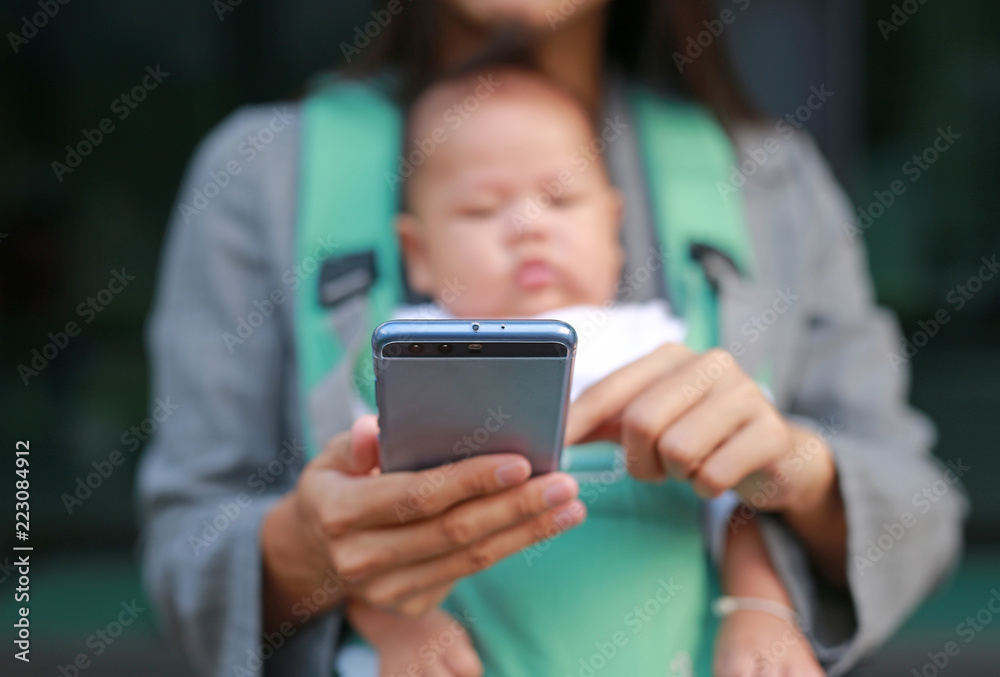 Close up business woman working by telephone with carrying her infant. Close up business woman working by telephone with carrying her infant.
