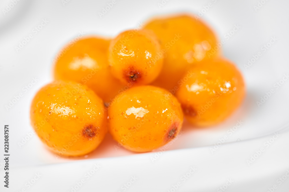 Sea buckthorn isolated on the white./Sea buckthorn on a porcelain plate. White background. Fruits of sea buckthorn. Sea buckthorn isolated on the white./Sea buckthorn on a porcelain plate. White background. Fruits of sea buckthorn.