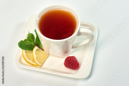 Raspberry tea./Tea with raspberries, lemon and mint. Hot drink.