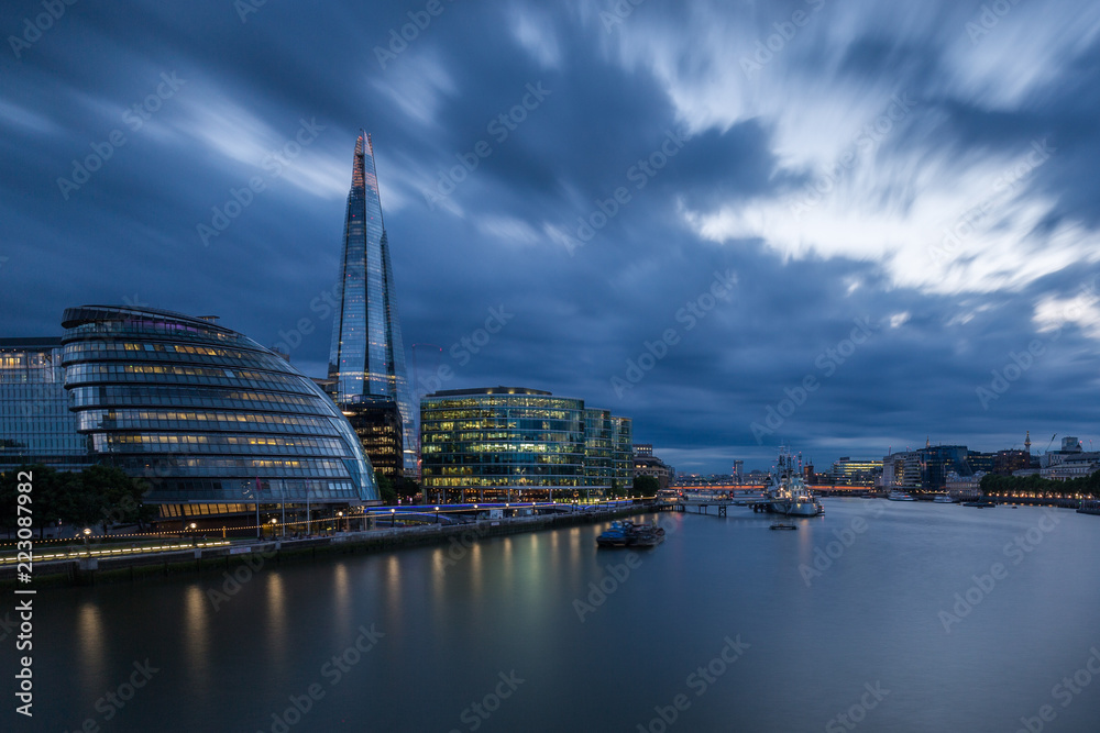 London's City Hall and the Shard with dramatic storm clouds