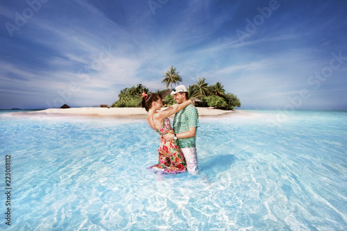 Guy and girl are standing at sea and hugging