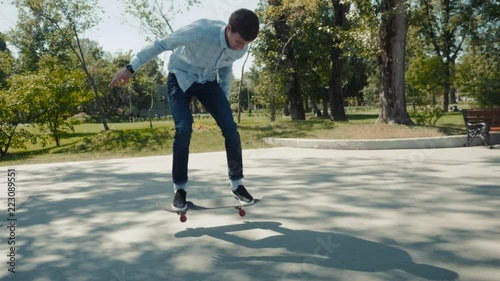 Close up of a skateboarders skater extreme trick feet while skating active teenager shot in the air on a skateboard in a skate park, street slow motion kickflip 360 flip ollie photo