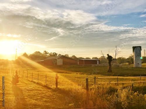Sun rising over lonely Indiana horse farm 